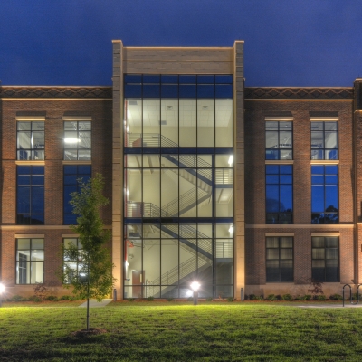 Alabama College of Osteopathic Medicine exterior with illuminated staircase