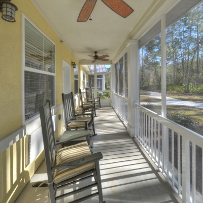 breezeway with charcoal colored rocking chairs.